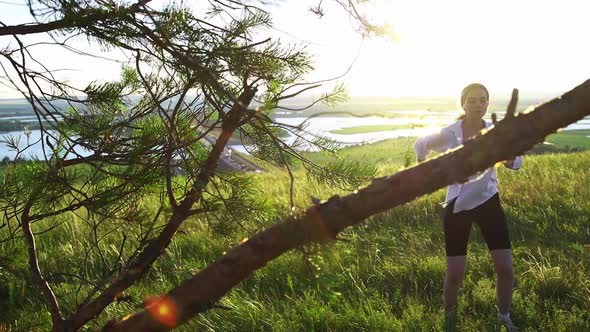 Swords Training  Young Woman Waving with a Sword on Nature in Daylight