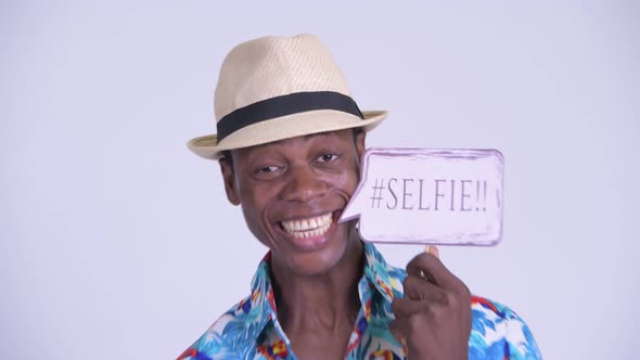 Face of Young Happy African Tourist Man Smiling with Selfie Paper Sign