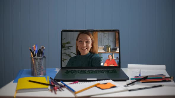 A Young Woman is Talking on a Video Call with a Young Man