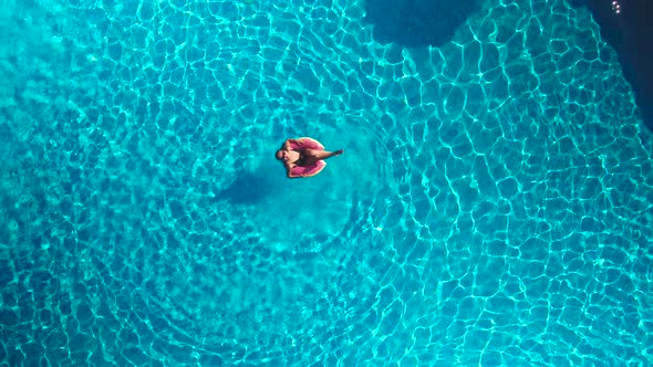 Girl in the Pool With an Inflatable Circle