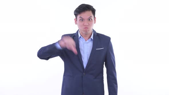 Angry Young Asian Businessman Giving Thumbs Down