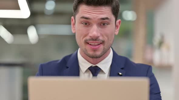 Close Up of Businessman Celebrating Success on Laptop