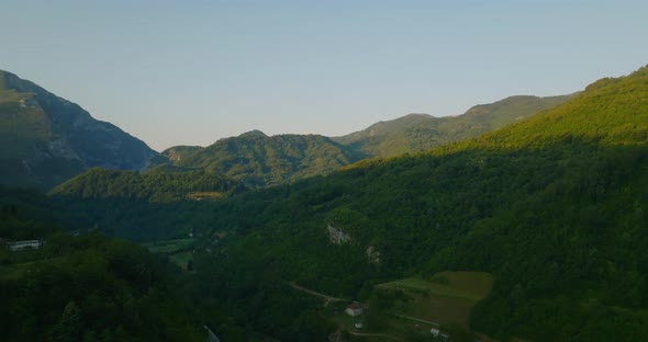 aerial view of sunrise in mountains with river in canyon