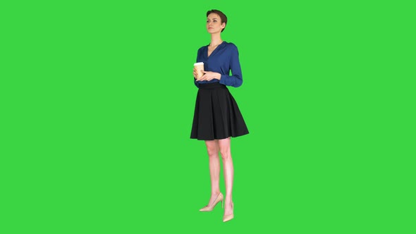 Pretty Woman Hold Paper Take Away Cup with Hot Beverage Black Coffee on a Green Screen, Chroma Key