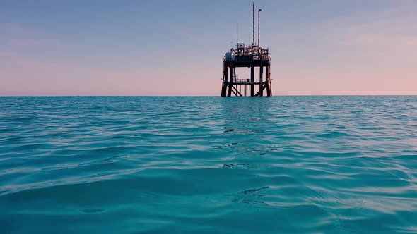 Low angle approach of offshore oil platform or gasoline rig in open ocean