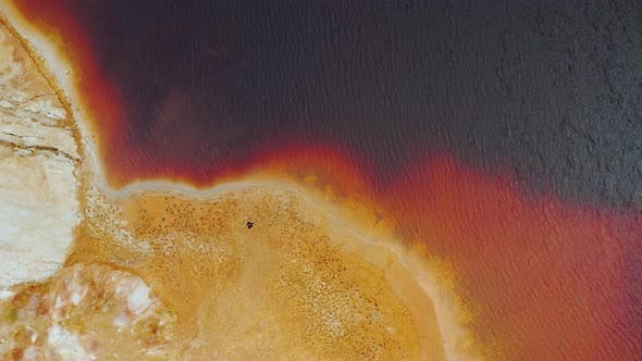 Mars planet Man is standing on the clay quarry and looking on the red water Ural Mars