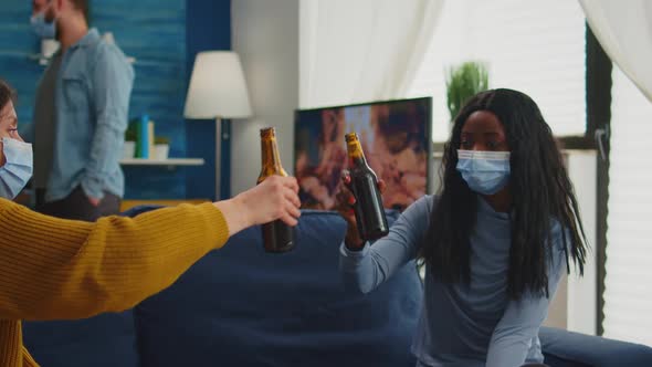 Multiracial Friends with Masks Enjoying a Beer During New Normal Party