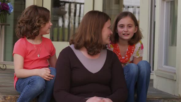 Portrait of family sitting on porch