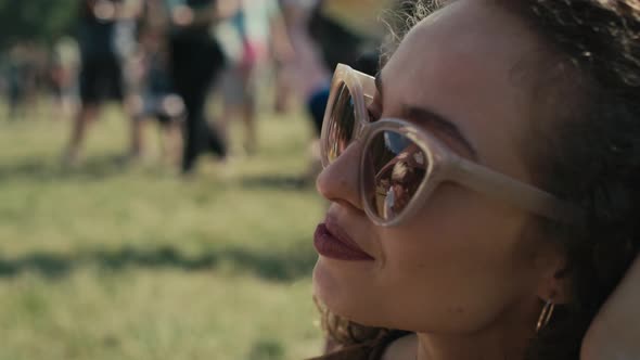 Close up of caucasian woman drinking beer from disposable cup at music festival. Shot with RED heliu