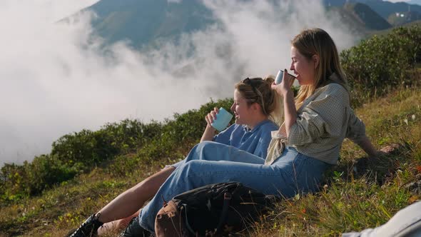 Travelling at Nature at Summer Vacation or Weekend Two Happy Female Friends are Drinking Tea on Halt