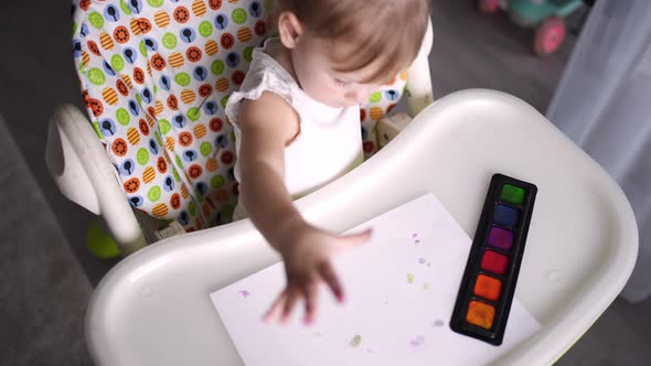 Cute Little Girl Painting with Fingers at Home