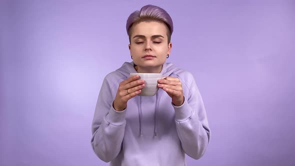 Young Woman Gen Z Smelling Sipping Hot Beverage in Mug Isolated