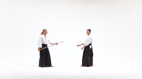 Two Males in Kimono Performing Aikido Using Bokken