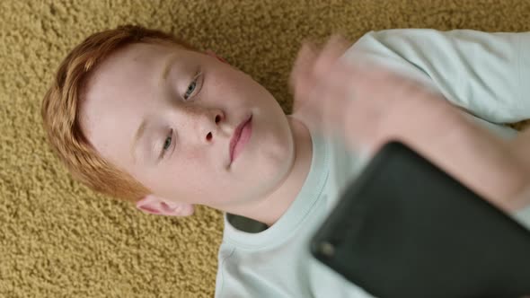 Teenage Boy Having Video Talk Using Phone