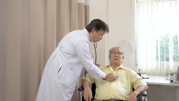 Doctor using stethoscope examine heart sounds check heart rate to older male patient during visit