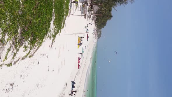 Vertical Video Kitesurfing Near the Shore of Zanzibar Tanzania Aerial View