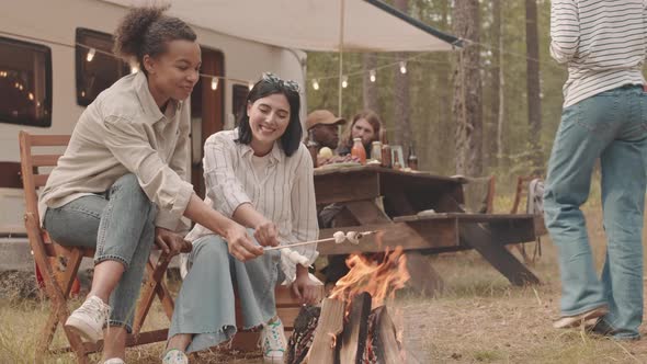 Girlfriends Making Fried Marshmallows on Campfire