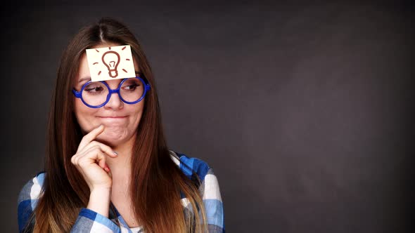 Woman Thinking Light Idea Bulb on Head