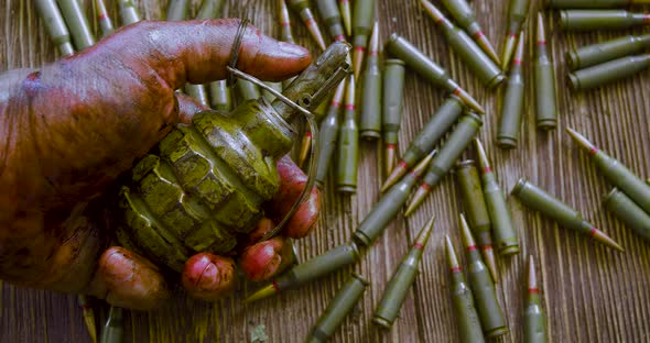 War Death and Suicide the Bloodied Hand of a Soldier or Rebel with a Grenade Against the Background