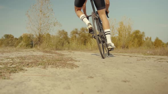Cyclist Riding On Gravel Bike In Slow Motion. Cyclist Athlete Workout Riding On Gravel Bicycle.