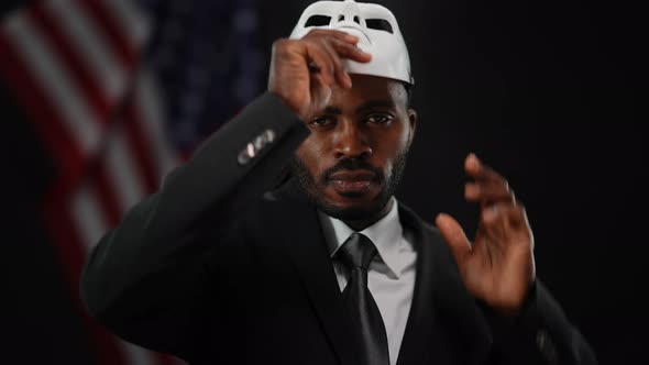 Confident African American Man Taking Off Disguise Mask Looking at Camera with Serious Facial