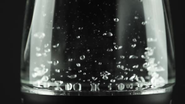 In a Electric Kettle with Glass Walls, Water Boils. Macro Studio Shot