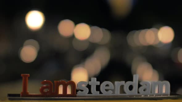Amsterdam slogan and night city lights