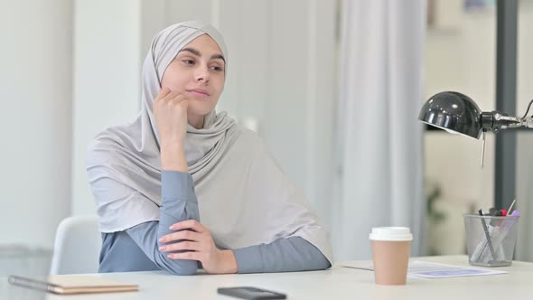 Young Arab Woman Thinking While Sitting in Office