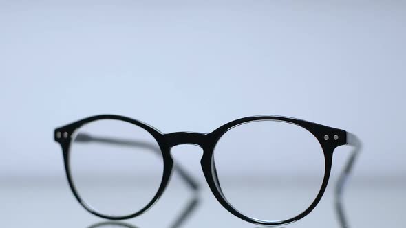 Female Hands Taking Eyeglasses From Table, Vision Correction, Nearsightedness