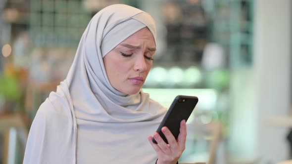 Portrait of Young Arab Woman Having Loss on Smartphone 