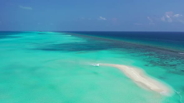 Aerial top view panorama of relaxing lagoon beach time by blue green sea with bright sand background