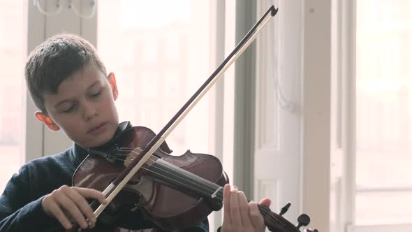 Boy playing violin during lesson