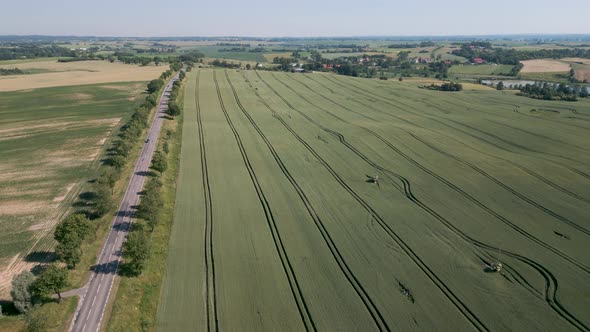 Grain field in the Mazury Region in Poland - Drone flight aerial bird flyover a field in Warmian-Mas