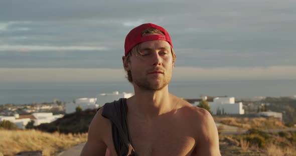 Man Walking Along Wearing Red Cap