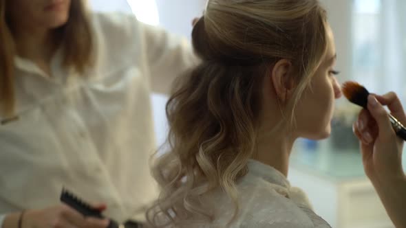 Back View of Professional Hairdresser Making Hairstyle Young Attractive Woman