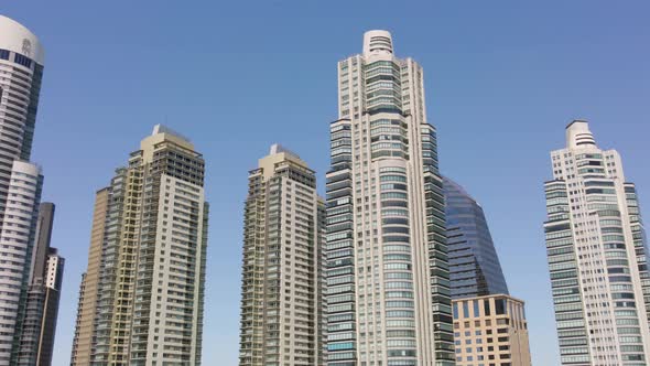 Aerial low angle shot of the top of Buenos Aires skyscrapers against the blue sky