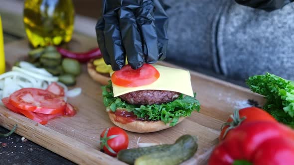 Making Burger  Putting Slices of Tomato on a Cheddar Cheese