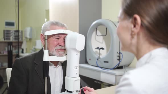 Ophthalmologist Examination of Elderly Man on Corneo Topographer