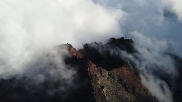 Drone footage of clouds over the summit of the Piton des Neiges at the Reunion island.