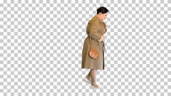 Thick brunette woman in a trench coat walking, Alpha Channel