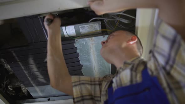 Experienced Repairman Finds Leak in System and Skillfully Fixing It, Maintenance