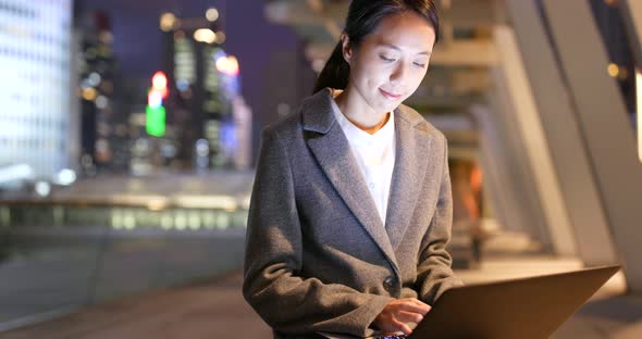 Businesswoman use of notebook computer at night