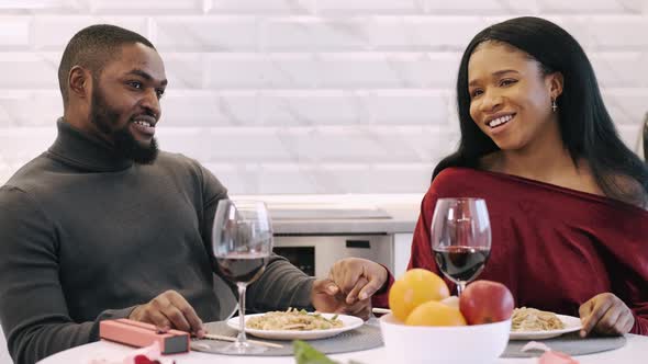 Young Couple Having Dinner at Home and Celebrating Saint Valentine