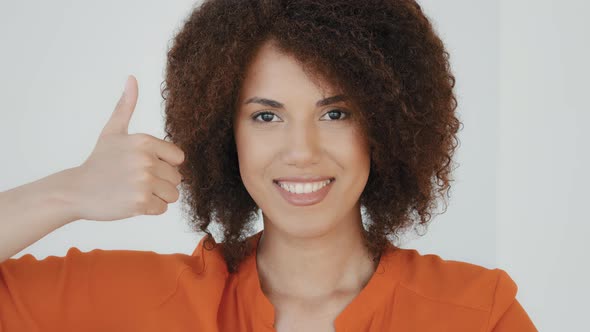 Smiling Cheerful African American Happy Woman with Curly Hairstyle Showing Thumb Up Looking at