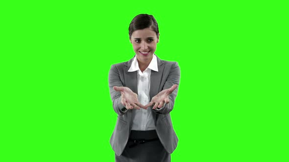 Businesswoman gesturing against green screen
