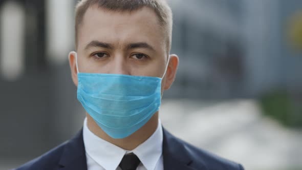 Portrait of a Young Businessman Wearing Protective Mask on Street