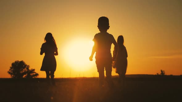 Happy Young Mother with a Children Play Together on Park