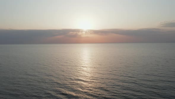 AERIAL: Calm and Romantic Baltic Sea on a Lovely Spring evening with Sun Setting Down