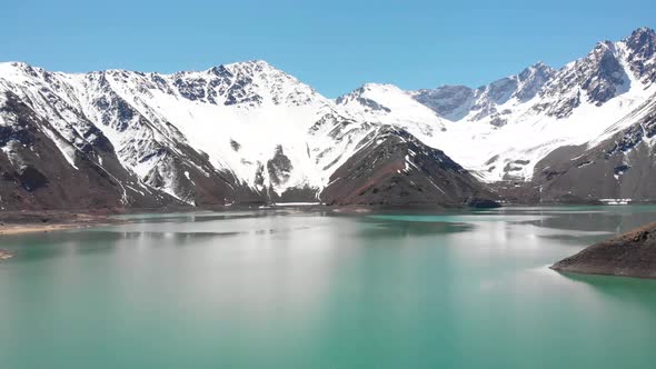 Aerial shot at low altitude over reservoir at Chilean Cordillera de los Andes-4K