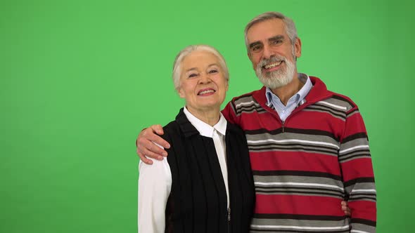 An Elderly Couple Laughs and Smiles at the Camera - Green Screen Studio